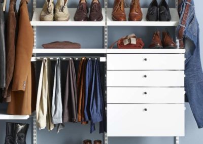 walk in closet with drawers and shoe racks