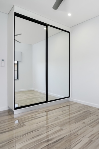Territory Homes Mirror Sliding Doors with Black Frames